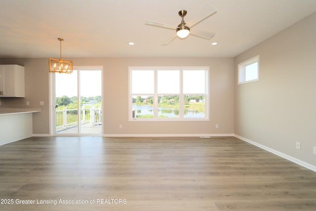 605 Landbridge, Perry, MI 48872 - unfurnished living room featuring a chandelier, recessed lighting, light wood-style flooring, and ceiling fan