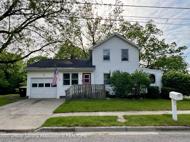 125 N E St, Mason, MI 48854 - traditional-style home with a garage, a front yard, and concrete driveway