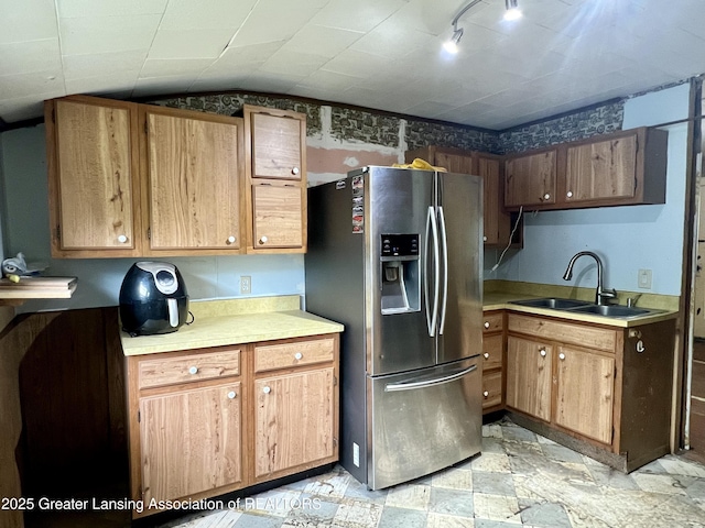 125 N E St, Mason, MI 48854 - kitchen featuring stainless steel fridge with ice dispenser, a sink, light countertops, and lofted ceiling