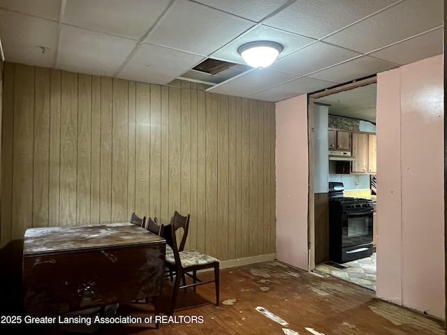 125 N E St, Mason, MI 48854 - office area featuring wood walls, a paneled ceiling, and wood finished floors