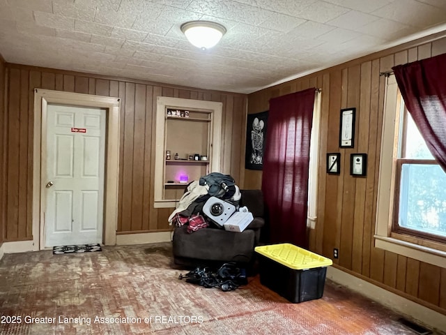 125 N E St, Mason, MI 48854 - sitting room featuring wood walls, baseboards, and brick patterned flooring