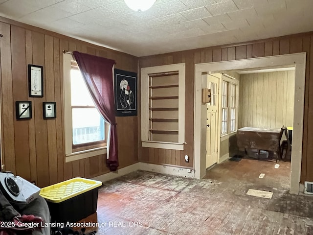 125 N E St, Mason, MI 48854 - interior space with wooden walls and baseboards