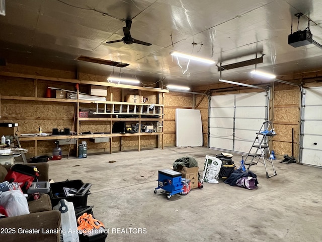 125 N E St, Mason, MI 48854 - garage featuring a garage door opener and ceiling fan