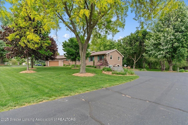 1055 Hull Rd, Mason, MI 48854 - single story home with a garage and a front yard