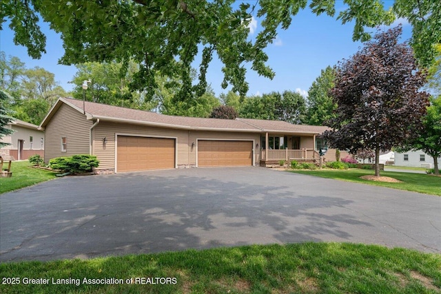 1055 Hull Rd, Mason, MI 48854 - single story home with a garage and asphalt driveway