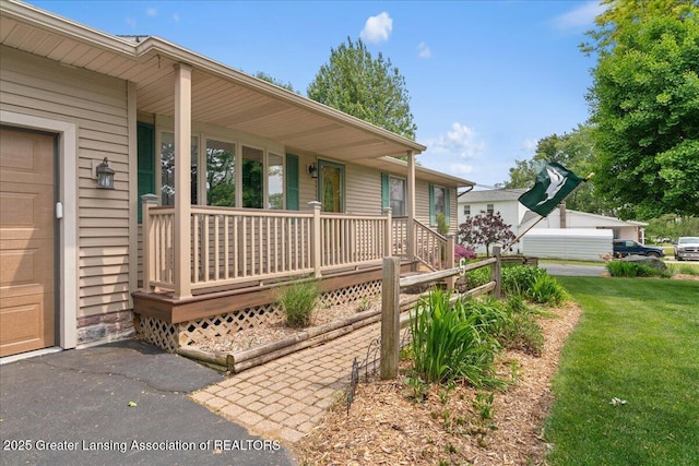 1055 Hull Rd, Mason, MI 48854 - property entrance with a porch and a yard