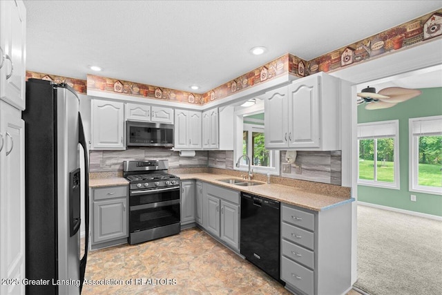 1055 Hull Rd, Mason, MI 48854 - kitchen with gray cabinets, stainless steel appliances, a sink, tasteful backsplash, and recessed lighting