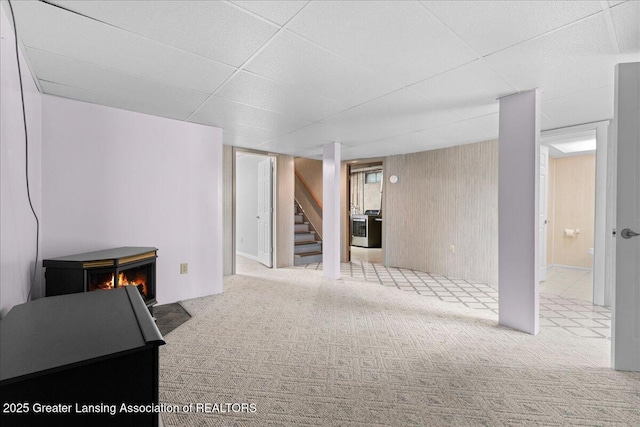 1055 Hull Rd, Mason, MI 48854 - finished basement featuring stairs, carpet flooring, and a warm lit fireplace
