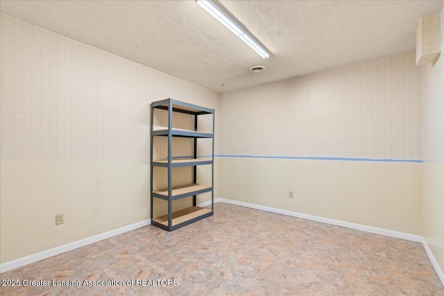1055 Hull Rd, Mason, MI 48854 - empty room with a textured ceiling and baseboards