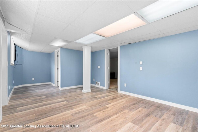 1055 Hull Rd, Mason, MI 48854 - finished basement featuring light wood-style floors, a drop ceiling, and baseboards