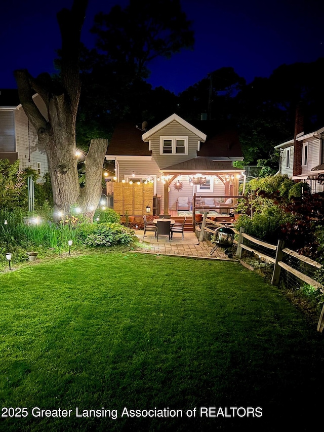 826 Clyde St, Lansing, MI 48915 - yard at twilight featuring a patio