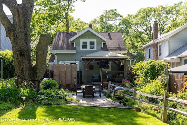 826 Clyde St, Lansing, MI 48915 - back of property with a gazebo, a patio, and roof with shingles