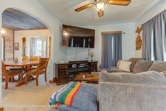 826 Clyde St, Lansing, MI 48915 - living room featuring arched walkways, light carpet, and ceiling fan