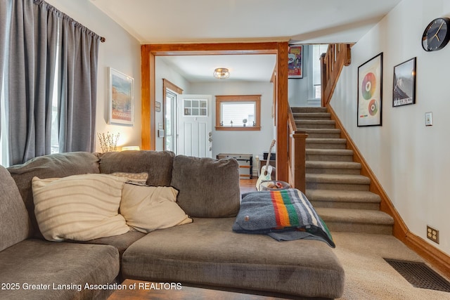 826 Clyde St, Lansing, MI 48915 - living area featuring stairs and baseboards