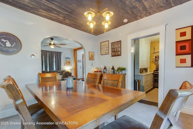 826 Clyde St, Lansing, MI 48915 - dining space featuring arched walkways, a ceiling fan, light colored carpet, a chandelier, and wood ceiling