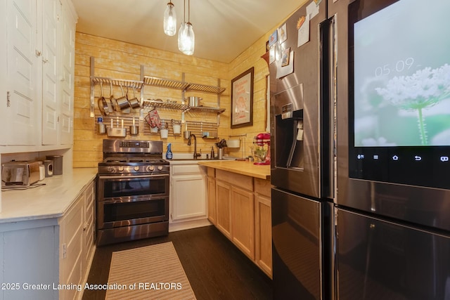 826 Clyde St, Lansing, MI 48915 - kitchen with appliances with stainless steel finishes, a sink, light countertops, and dark wood-type flooring