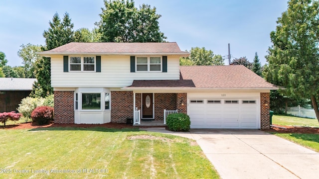 120 Chanticleer Trl, Lansing, MI 48917 - view of front facade featuring brick siding, an attached garage, and driveway