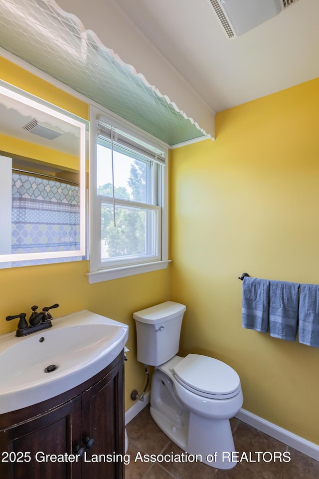 120 Chanticleer Trl, Lansing, MI 48917 - full bathroom with toilet, vanity, baseboards, and tile patterned flooring