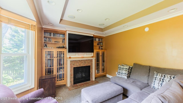 120 Chanticleer Trl, Lansing, MI 48917 - carpeted living area with a raised ceiling, healthy amount of natural light, crown molding, and a fireplace