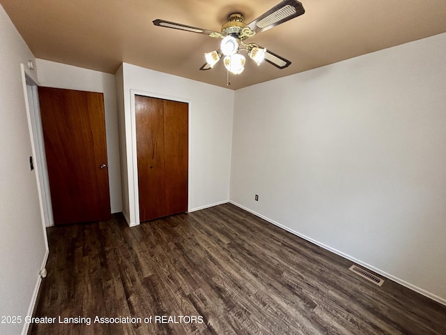 1143 Lathrop St, Lansing, MI 48912 - unfurnished bedroom with dark wood finished floors, a closet, and baseboards