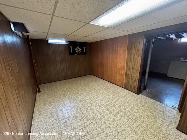1143 Lathrop St, Lansing, MI 48912 - finished basement featuring wooden walls, a drop ceiling, and light floors