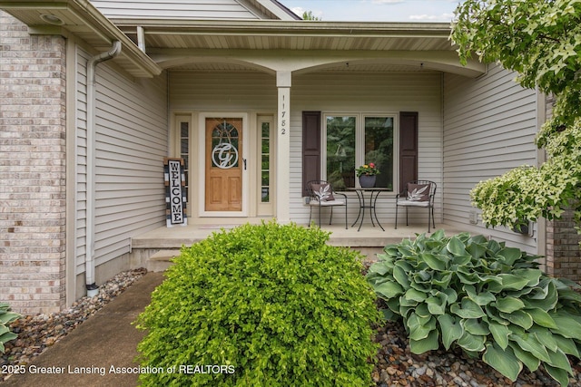 11782 Sara Ann Dr, Dewitt, MI 48820 - doorway to property with a porch and brick siding