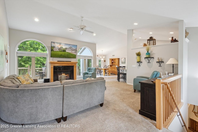 11782 Sara Ann Dr, Dewitt, MI 48820 - living room with a ceiling fan, healthy amount of natural light, a glass covered fireplace, light carpet, and lofted ceiling