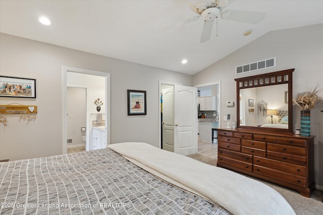 11782 Sara Ann Dr, Dewitt, MI 48820 - bedroom with vaulted ceiling, ensuite bath, recessed lighting, a ceiling fan, and a sink