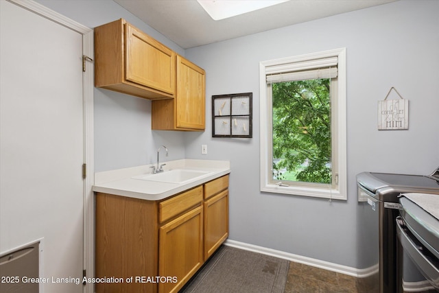 11782 Sara Ann Dr, Dewitt, MI 48820 - laundry area featuring independent washer and dryer, cabinet space, baseboards, and a skylight