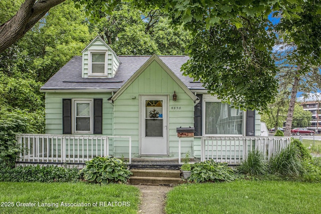 4434 Holt Rd, Holt, MI 48842 - view of front of house featuring roof with shingles and covered porch