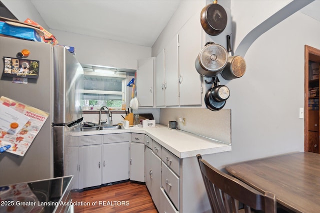 925 Summit St, Owosso, MI 48867 - kitchen with freestanding refrigerator, a sink, light countertops, dark wood finished floors, and white cabinetry