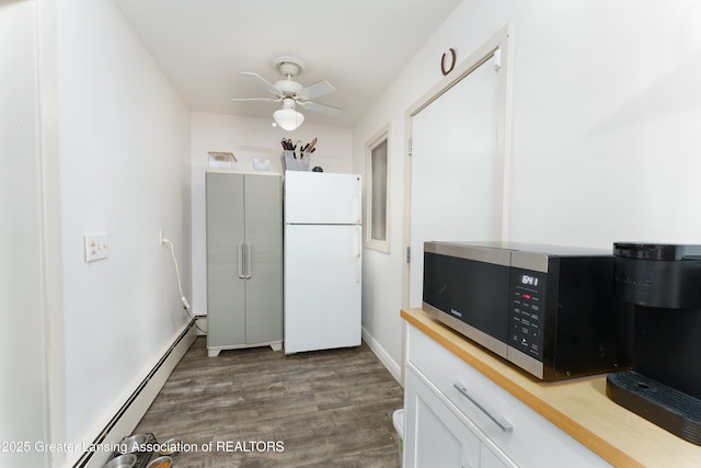 5013 Algonquin Way, Okemos, MI 48864 - kitchen featuring freestanding refrigerator, stainless steel microwave, a baseboard heating unit, wood finished floors, and ceiling fan