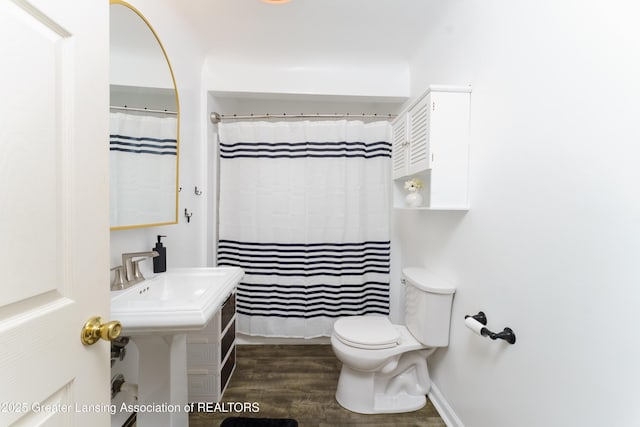5013 Algonquin Way, Okemos, MI 48864 - bathroom with toilet, wood finished floors, and a shower with shower curtain