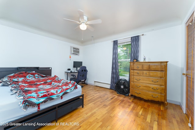 5013 Algonquin Way, Okemos, MI 48864 - bedroom with a baseboard heating unit, light wood finished floors, a wall unit AC, ceiling fan, and a closet