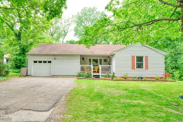 5013 Algonquin Way, Okemos, MI 48864 - single story home with a garage, asphalt driveway, a front lawn, and covered porch