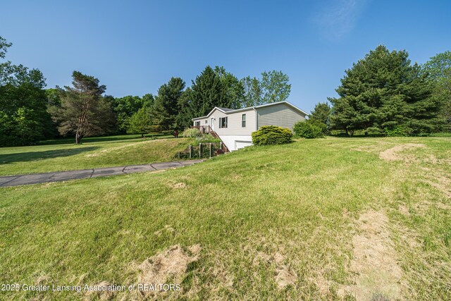 1200 S Michigan Rd, Eaton Rapids, MI 48827 - view of grassy yard with a garage