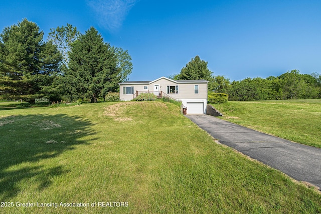 1200 S Michigan Rd, Eaton Rapids, MI 48827 - manufactured / mobile home with an attached garage, asphalt driveway, and a front yard