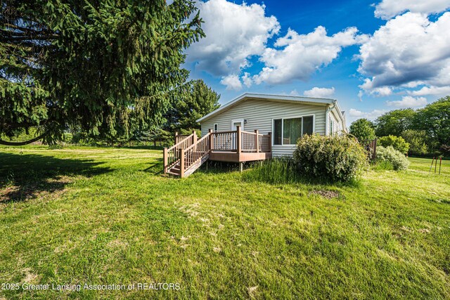 1200 S Michigan Rd, Eaton Rapids, MI 48827 - back of house with a deck and a lawn