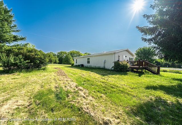 1200 S Michigan Rd, Eaton Rapids, MI 48827 - view of grassy yard featuring a wooden deck