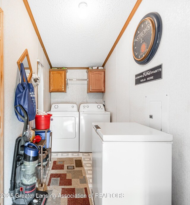 1200 S Michigan Rd, Eaton Rapids, MI 48827 - laundry room featuring independent washer and dryer, cabinet space, a textured ceiling, and ornamental molding