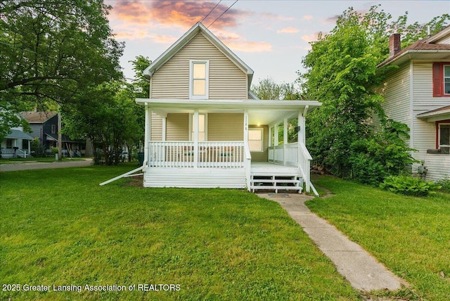1128 Hickory St, Lansing, MI 48912 - view of front of home featuring covered porch and a lawn