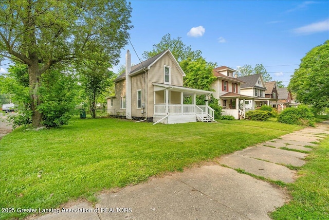 1128 Hickory St, Lansing, MI 48912 - view of front of house featuring a porch, a chimney, and a front yard