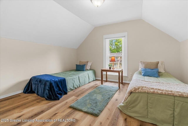 1128 Hickory St, Lansing, MI 48912 - bedroom featuring wood finished floors, vaulted ceiling, and baseboards