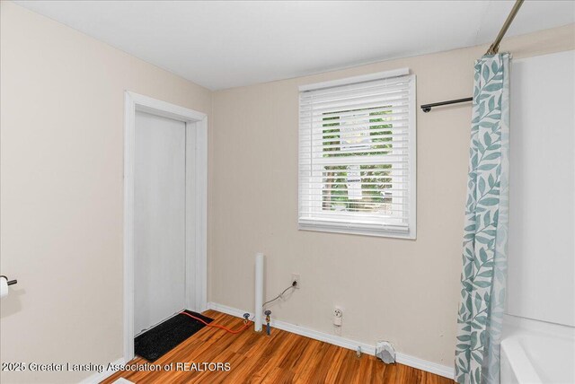 1128 Hickory St, Lansing, MI 48912 - unfurnished bedroom featuring wood finished floors and baseboards
