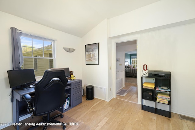 2038 Woodfield Rd, Okemos, MI 48864 - office area with light wood-type flooring, vaulted ceiling, and baseboards