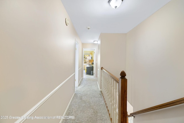 2038 Woodfield Rd, Okemos, MI 48864 - corridor featuring an upstairs landing, light carpet, and baseboards