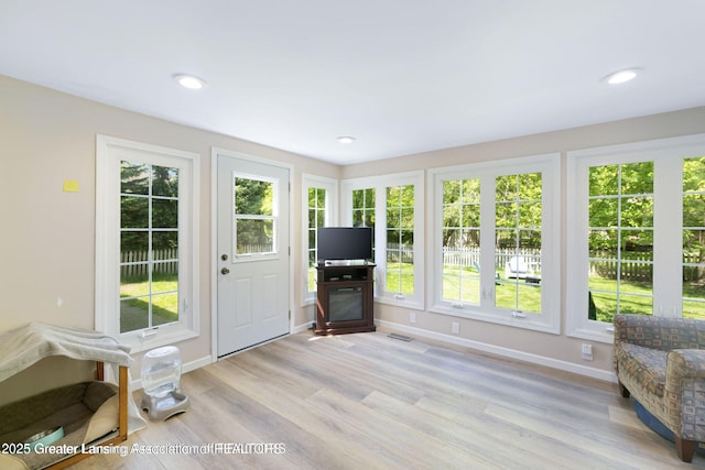 2038 Woodfield Rd, Okemos, MI 48864 - sunroom / solarium featuring wood finished floors, baseboards, and recessed lighting