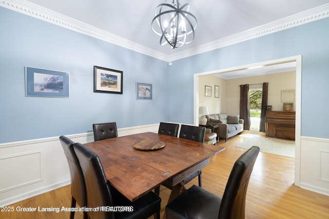 2038 Woodfield Rd, Okemos, MI 48864 - dining area with a chandelier, light wood-style flooring, wainscoting, and ornamental molding