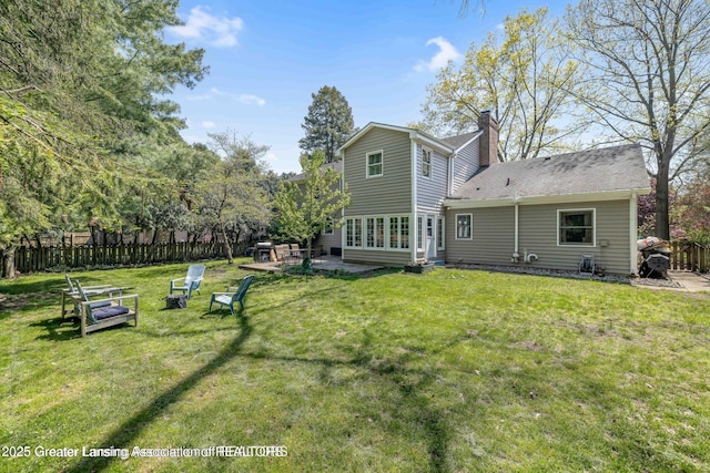 2038 Woodfield Rd, Okemos, MI 48864 - back of property with a chimney and a patio area