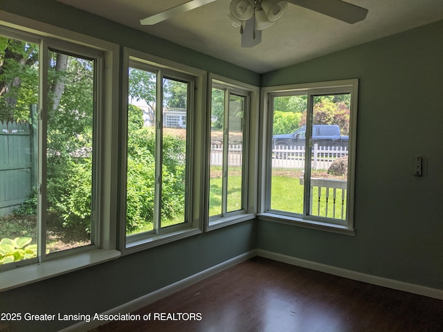 15632 Park Lake Rd, East Lansing, MI 48823 - unfurnished sunroom with baseboards, plenty of natural light, wood finished floors, and lofted ceiling